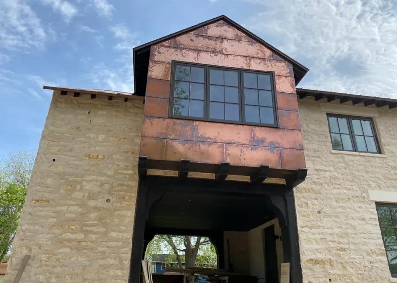 Copper metal panel facade on a stone building for Metal Roof Coating in Hurley